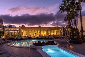 a resort with a swimming pool and a building at Oasis Lanz Beach Mate in Costa Teguise