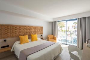 a hotel room with a bed and a balcony at Oasis Lanz Beach Mate in Costa Teguise