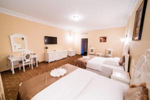 A bed or beds in a room at Aphrodite Palace