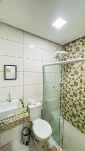 a bathroom with a toilet and a sink and a shower at Tô em Casa in Lençóis +59 photos