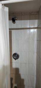 a shower with a sink and a shower curtain at Bedroom with double bed in Mississauga