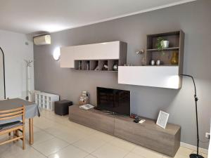 a living room with a tv and a fireplace at Super Location front lake in Sirmione