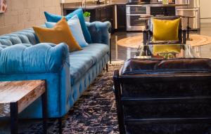 a living room with a blue couch and two chairs at Petaluma Warehouse Lofts Unit D in Petaluma