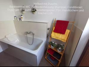 a bathroom with a sink and a red towel on a shelf at Unikat im Zentrum in Schwerin +6 photos