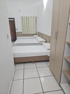 Rúm í herbergi á Hotel Marambaia Ponta Porã