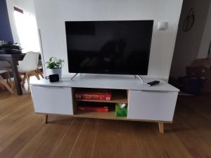 a white entertainment center with a flat screen tv on it at Unikat im Zentrum in Schwerin