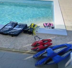 a group of luggage sitting next to a swimming pool at Las Brisas Azules in Providenciales