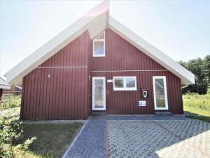 a red barn with a white roof at Ferienhaus mit privater Sauna in Granzow