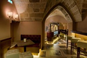 a restaurant with an archway and a table and chairs at Le Club Boutique Hotel in Lecce
