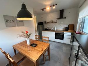 a kitchen and dining room with a wooden table and chairs at WALLENSTAY Apartment in Altdorf bei Nuernberg