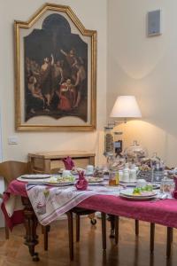 a dining room with a table with plates of food at B&B Annabel in Milan
