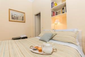 a bedroom with a bed with a tea set on it at B&B Annabel in Milan