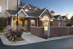 a house with a for sale sign in front of it at TownePlace Suites by Marriott Brookfield in Brookfield