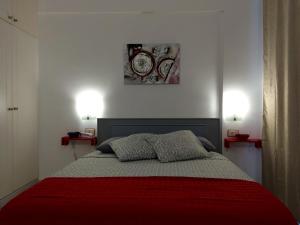 een slaapkamer met een bed met rode deken en twee lampen bij Ponderosa Holiday Studio 701 in Playa de las Americas +27 foto's