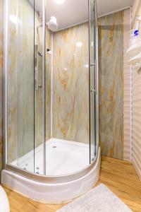 a shower with a glass door in a bathroom at Blue Morpho Lodge & Spa in Bajos del Toro +71 photos
