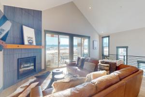 a living room with a couch and a fireplace at Mountain Bliss Retreat in Granby in Granby
