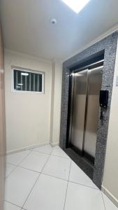 an empty room with a door and a window at Apto Lírio da Paz- 3 Quartos com sacadas,espaçoso e de frente para avenida principal! in Piratuba