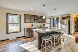 a kitchen with a large island with bar stools at Golf, Hike and Boat Home with Fire Pit in Friendship in Friendship
