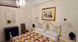 a bedroom with a bed and a picture on the wall at Apartments Mikros in Giardini Naxos