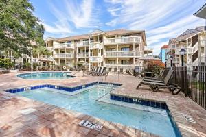 a swimming pool in front of a apartment building at Ocean View Ground Floor Pool and Hot Tub in Myrtle Beach