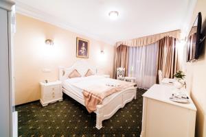 A bed or beds in a room at Aphrodite Palace