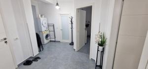 a hallway with a living room with a television and a room with at Apartment rent Elbasan city center 1 in Elbasan