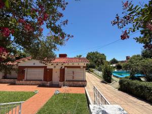 a house with a pool in the yard at Nuevo complejo Clarita in Villa Carlos Paz