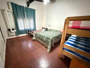 a bedroom with two bunk beds and a window at Nuevo complejo Clarita in Villa Carlos Paz