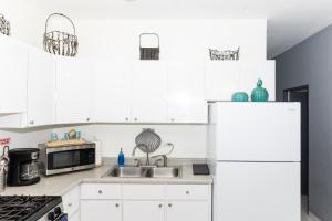 a kitchen with white cabinets and a white refrigerator at Casa Marino - RELAX just minutes from Beaches in Llanos Tuna