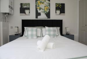 a bedroom with a white bed with flowers on it at Stadium View, by Cardiff Central, Free Parking in Cardiff