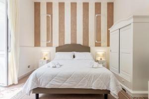 a bedroom with a large bed with two night stands at Aragona House in Palermo