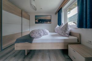 a bed in a room with a window at Apartment Linde in Lermoos
