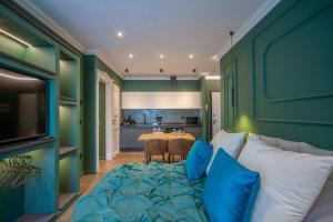 a room with a couch and a table with blue pillows at MENTORE MAISON PRESTiGE in Noceto