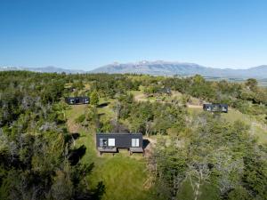 an aerial view of a house on a hill with trees at Tylluan Lodge in Trevelín