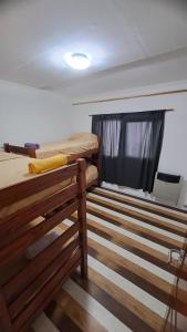 Giường trong phòng chung tại Casa en Ushuaia