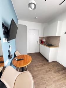 a living room with a table and chairs and a kitchen at Modern Studio 7 private Kitchenette and Bathroom in Limassol