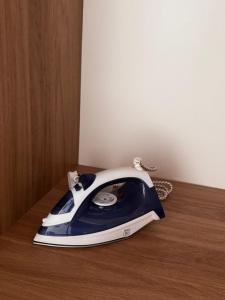 a blue and white phone sitting on a wooden table at Modern Studio 7 private Kitchenette and Bathroom in Limassol