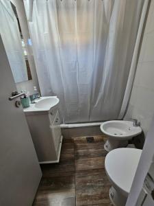 a bathroom with a sink and a toilet and a shower at valeriadelmar in Valeria del Mar