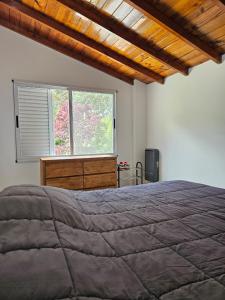 a bedroom with a large bed and a window at valeriadelmar in Valeria del Mar
