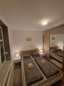 a bedroom with two beds and two candles on them at Vila Velebita in Vukovar +21 photos