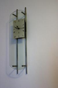 a clock is hanging on a wall at Discover Italy in Tignes