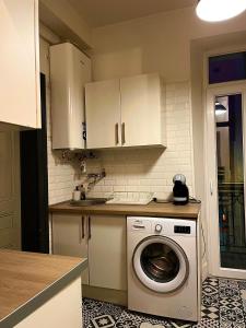 a kitchen with a washing machine in a kitchen at Nid des lumières in Bellegarde-sur-Valserine +10 photos
