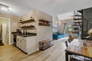 a kitchen and living room with a counter and a table at Renovated Ski In Ski Out Condo at Holiday Valley in Ellicottville
