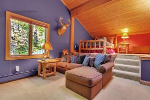 a living room with a couch and a bed at Spacious Chalet Hot Tub Sauna Holiday Valley in Ellicottville