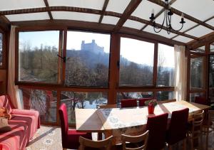 a room with a table and chairs and a large window at Ferienhaus Burgblick Eichstätt in Eichstätt