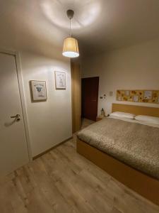a bedroom with a bed and a light at Il Giardino Segreto in Assisi