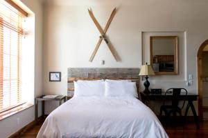a bedroom with a bed with a large clock on the wall at Studio 508 in Leadville