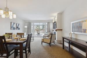 a dining room and living room with a table and chairs at Blue Mountain Retreat at Rivergrass in Blue Mountains