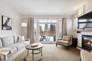 a living room with a couch and a fireplace at Blue Mountain Retreat at Rivergrass in Blue Mountains
