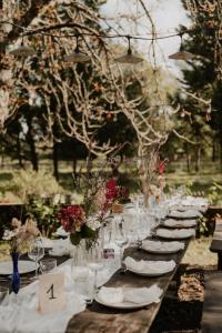 a long table with plates and wine glasses on it at Chateau de la Vieille Chapelle in Lugon et l’Ile du Carney